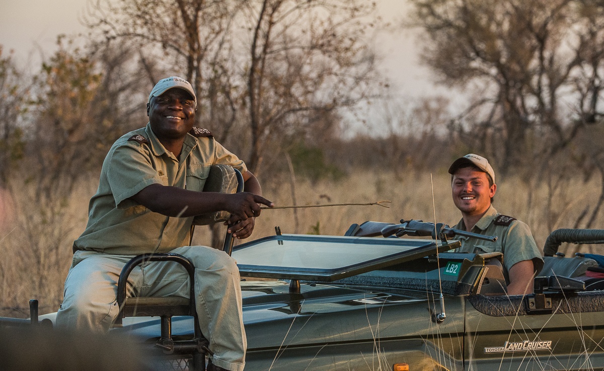 Safari guides and guests on safari vehicle